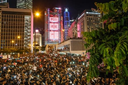 Demonstrators wave their smartphones during a rally ahead of the G20 summit, urging the international community to back their demands for the government to withdraw a the extradition bill in Hong Kong