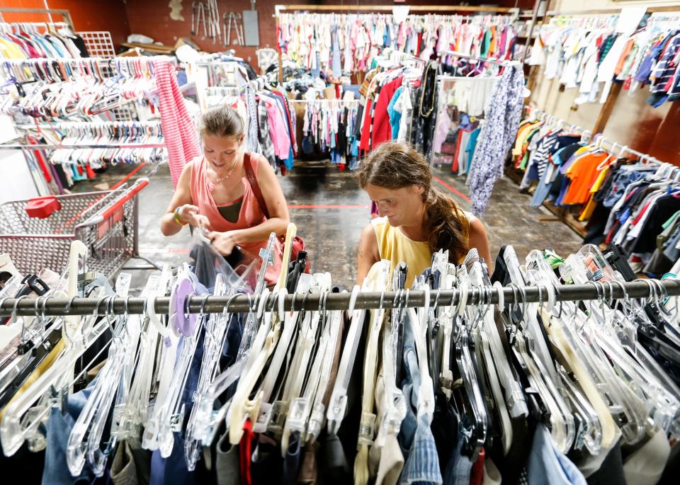 Eden Williams (left) and Shawna Ince browse clothes in the clothing pantry at The Connecting Grounds church on Commercial Street on Tuesday, July 16, 2019.