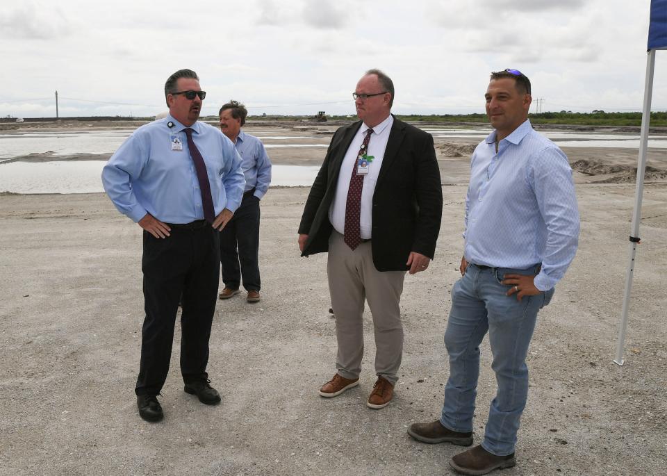 Jon Prince (From Left) Superintendent of St. Lucie Schools, Terence O'Leary COO of St. Lucie Schools, and  Ted Cava, Vice President with Core Construction, overlook the progress on land clearing for the new high school, known as Tradition DDD along Range Line Road, south of Glades Cutoff Road, during a tour with the schoolboard members and associates on Wednesday, May 31, in southern Port St. Lucie. "The project is staying on schedule, 250, 000 square feet, 2000 student stations, and it's on 50 acres," Cava said. 