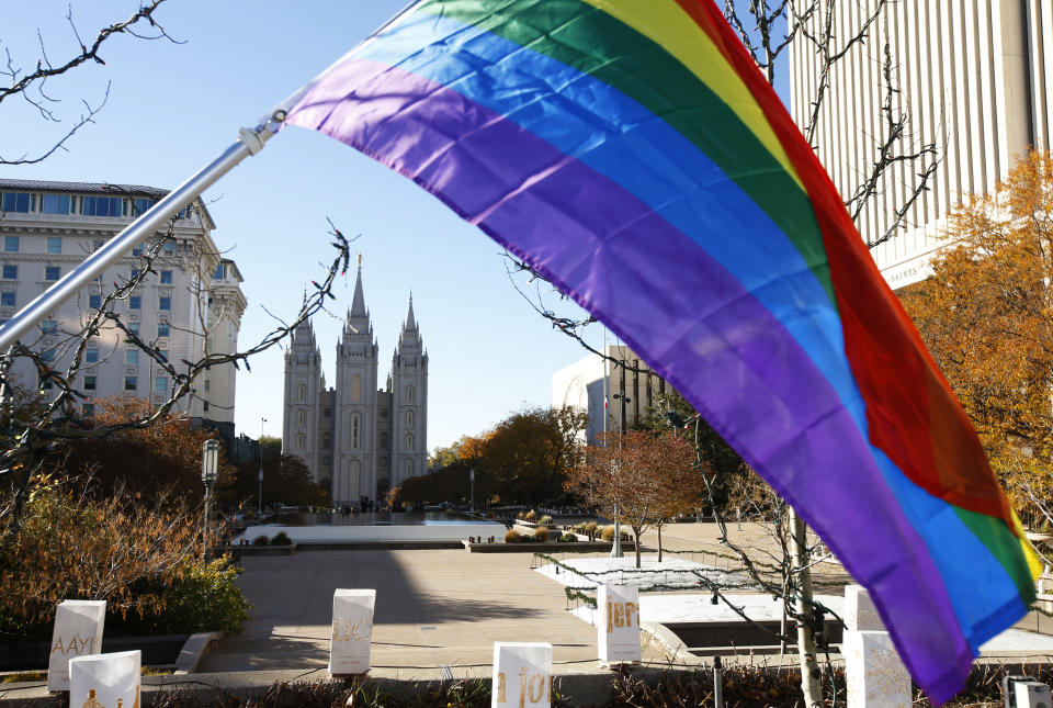 SALT LAKE CITY, UT - NOVEMBER14: A pride flag flies in front of the Historic Mormon Temple as part of a protest where people resigned from the Church of Jesus Christ of Latter-Day Saints in response to a recent change in church policy towards married LGBT same sex couples and their children on November 14, 2015 in Salt Lake City, Utah. A little over a week ago the Mormon church made a change in their official handbook of instructions requiring a disciplinary council and possible excommunication for same sex couples and banning the blessing and baptism of their children into the church. (Photo by George Frey/Getty Images)