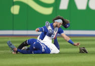 Toronto Blue Jays shortstop Bo Bichette, rear, and center fielder George Springer collide while to trying to catch a short fly ball by Seattle Mariners J.P. Crawford during the eighth inning of Game 2 of a baseball AL wild-card playoff series Saturday, Oct. 8, 2022, in Toronto. Springer left the game. (Frank Gunn/The Canadian Press via AP)