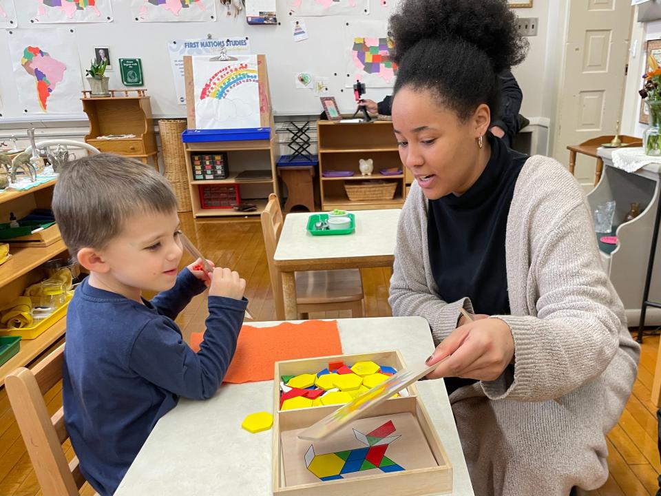 Paraprofessional LouOnnie Pryor helps K-3 student Clayton Proeber get started on an activity at Maryland Avenue Montessori School on March 21. Without a successful referendum on April 2, the school plans to lose five of its paraprofessionals.