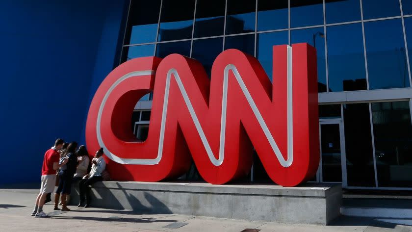 FILE - OCTOBER 6, 2014: According to reports, Turner Broadcasting, which includes CNN, TNT and TBS, is set to cut about 10% of its employees totaling about 1,475 jobs. ATLANTA, GA - NOVEMBER 29: People sit outside of the CNN Center on November 29, 2012 in Atlanta, Georgia. CNN announced that is has named former NBC Universal chief Jeff Zucker as its new top executive. (Photo by Kevin C. Cox/Getty Images) ** OUTS - ELSENT, FPG - OUTS * NM, PH, VA if sourced by CT, LA or MoD **