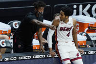 Miami Heat forward KZ Okpala (4) listens to teammate Jimmy Butler during the first half of an NBA basketball game against the Denver Nuggets, Wednesday, Jan. 27, 2021, in Miami. Butler has missed multiple games because of the NBA's health and safety protocols. (AP Photo/Marta Lavandier)