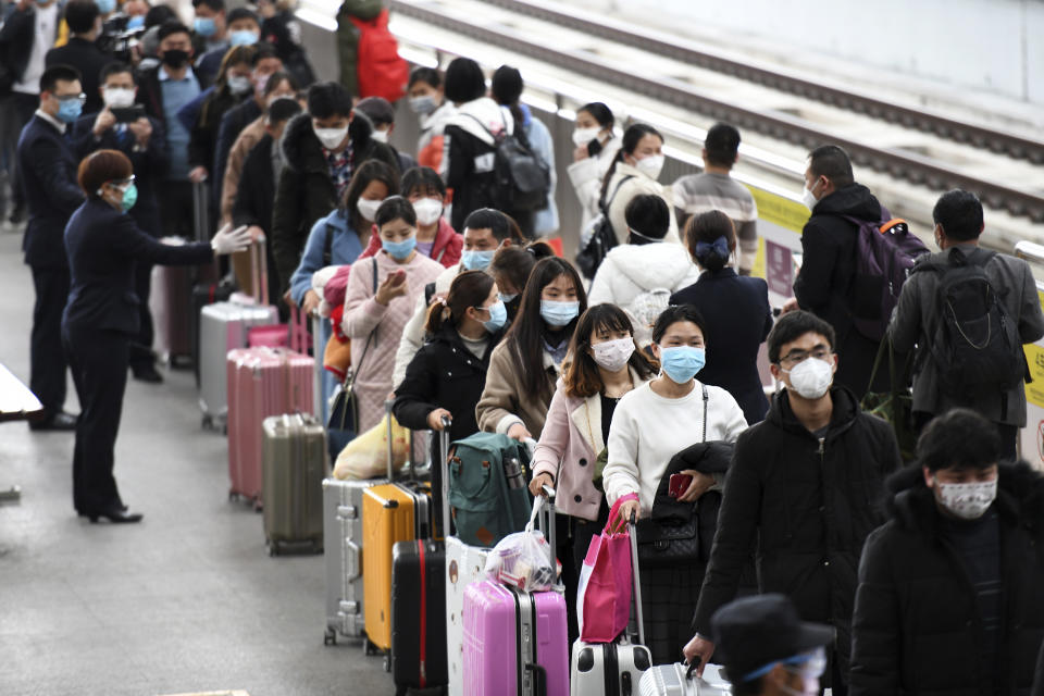 In this photo released by Xinhua News Agency, workers returning from Henan province alight from a specially arranged train at the Shenzhen North Railway Station before dividing into groups to be bused to their workplace in Shenzhen, southern China's Guangdong Province, March 5, 2020. Factories are gradually reopening in China months after the new coronavirus that first emerged there upended daily routines. While China looked for signs that life would return to normal, other parts of the world started to experience what the country and its people went through. (Liang Xu/Xinhua via AP) NO SALES