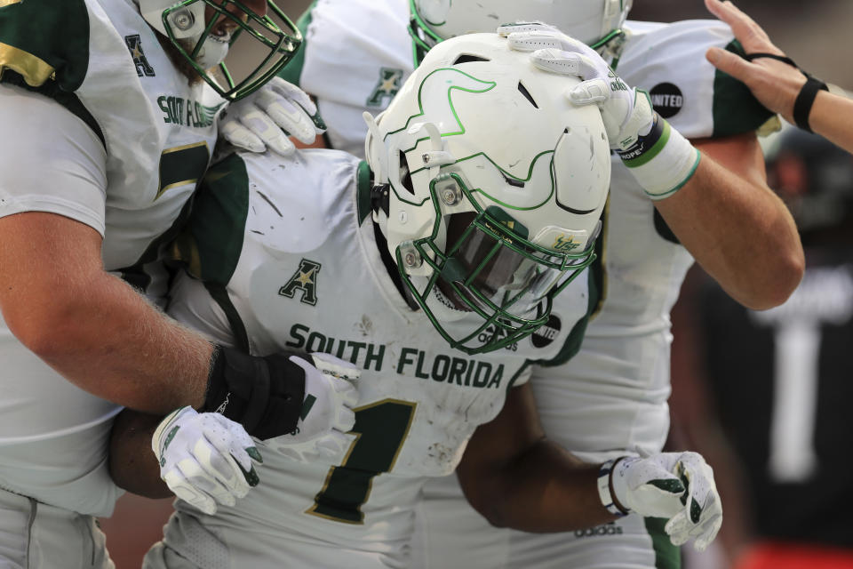 South Florida running back Johnny Ford celebrates with teammates after scoring a touchdown during the second half of an NCAA college football game against Cincinnati, Saturday, Oct. 3, 2020, in Cincinnati. (AP Photo/Aaron Doster)