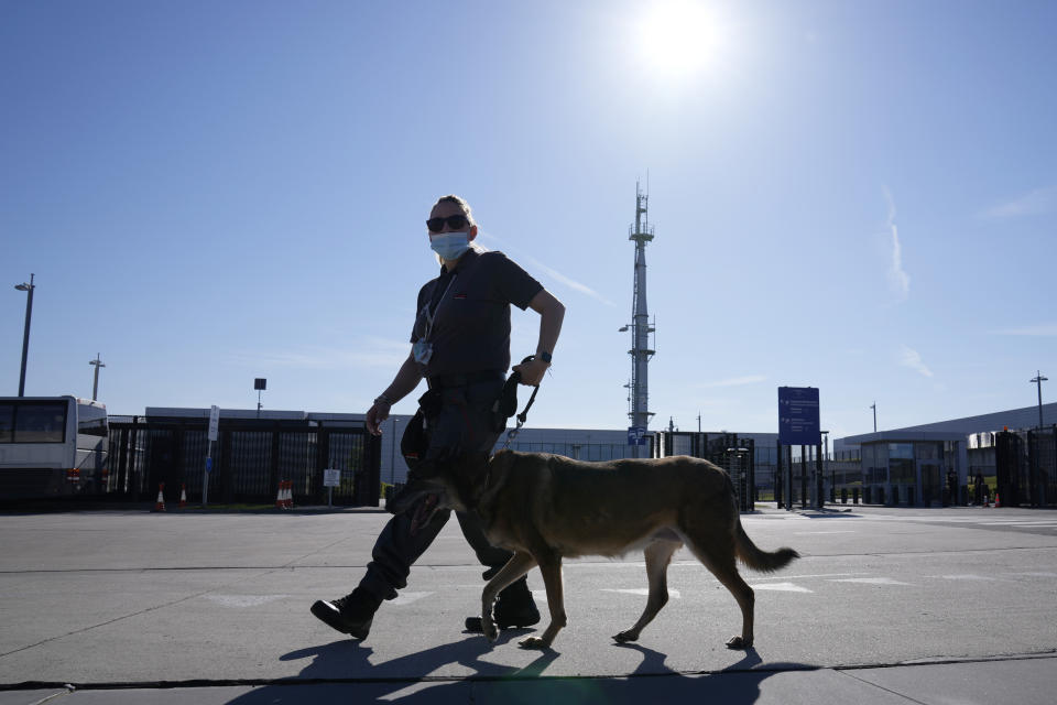 A member of security patrols with a dog during a NATO summit at NATO headquarters in Brussels, Monday, June 14, 2021. U.S. President Joe Biden is taking part in his first NATO summit, where the 30-nation alliance hopes to reaffirm its unity and discuss increasingly tense relations with China and Russia, as the organization pulls its troops out after 18 years in Afghanistan. (AP Photo/Francois Mori)