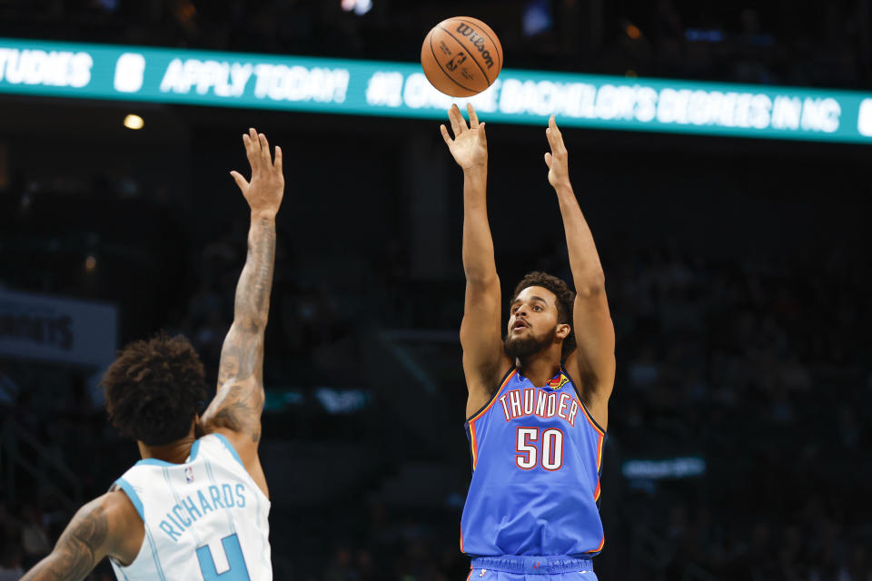 Oct 15, 2023; Charlotte, North Carolina, USA; Oklahoma City Thunder forward <a class="link " href="https://sports.yahoo.com/nba/players/6574" data-i13n="sec:content-canvas;subsec:anchor_text;elm:context_link" data-ylk="slk:Jeremiah Robinson-Earl;sec:content-canvas;subsec:anchor_text;elm:context_link;itc:0">Jeremiah Robinson-Earl</a> (50) shoots over Charlotte Hornets center <a class="link " href="https://sports.yahoo.com/nba/players/6434" data-i13n="sec:content-canvas;subsec:anchor_text;elm:context_link" data-ylk="slk:Nick Richards;sec:content-canvas;subsec:anchor_text;elm:context_link;itc:0">Nick Richards</a> (4) in the first half at Spectrum Center. Mandatory Credit: Nell Redmond-USA TODAY Sports