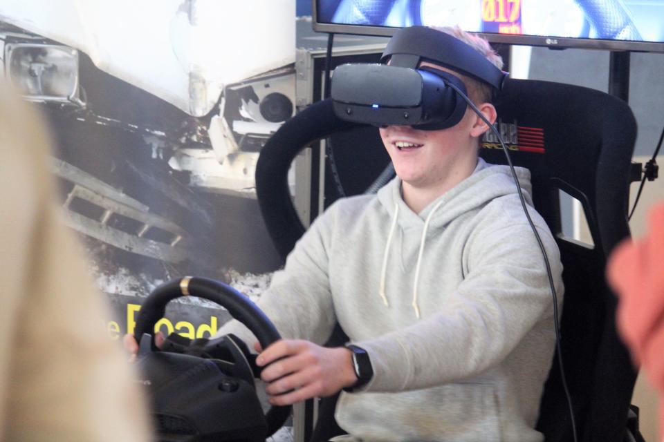 A student at Holland Christian High School uses a driving simulator with a VR headset on Friday, Jan. 27.