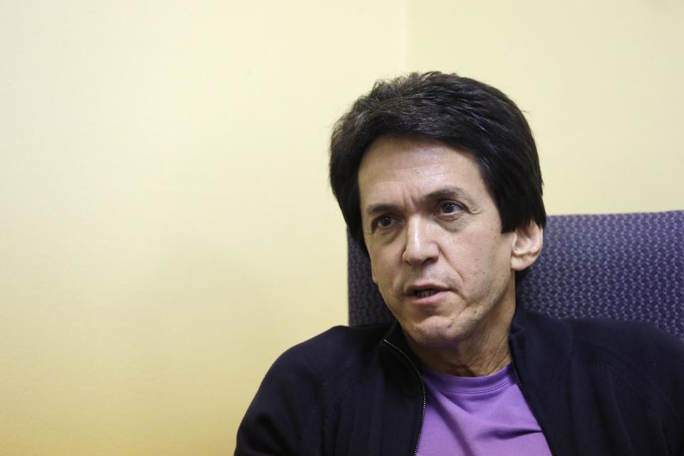 FILE - In this Nov. 7, 2013 file photo, author Mitch Albom is interviewed in Highland Park, Mich. Albom is an award-winning sports writer, best-selling author, radio host, TV pundit, songwriter and international philanthropist. Albom has launched a drive to rebuild 10 libraries in Tacloban, a central Philippine city ravaged by Typhoon Haiyan in November. National Book Store Foundation, his Philippine partner in the project, said Tuesday that Albom has pledged to raise $160,000, starting with his own contribution of $10,000 for the libraries. (AP Photo/Carlos Osorio, File)