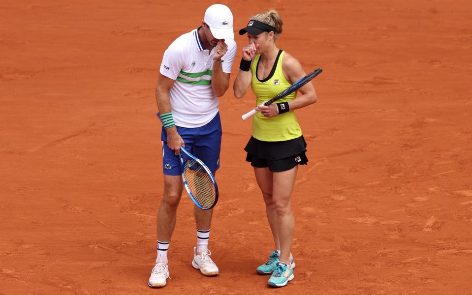 Doubles players communicate between points, as seen with 2024 French Open finalists Neal Skupski, of Great Britain, and Desirae Krawczyk, of the USA