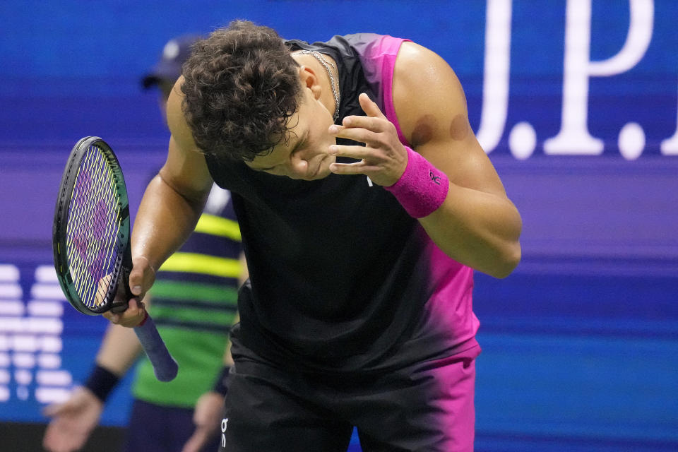 Ben Shelton, of the United States, reacts during a match against Novak Djokovic, of Serbia, during the men's singles semifinals of the U.S. Open tennis championships, Friday, Sept. 8, 2023, in New York. (AP Photo/Charles Krupa)