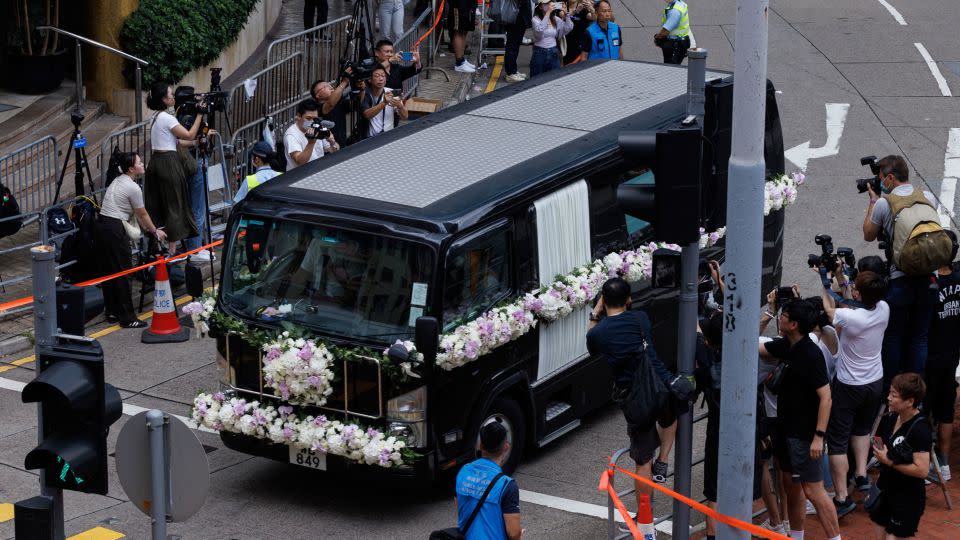 The hearse carrying the casket of singer and songwriter CoCo Lee departs from a funeral home in Hong Kong. - Tyrone Siu/Reuters