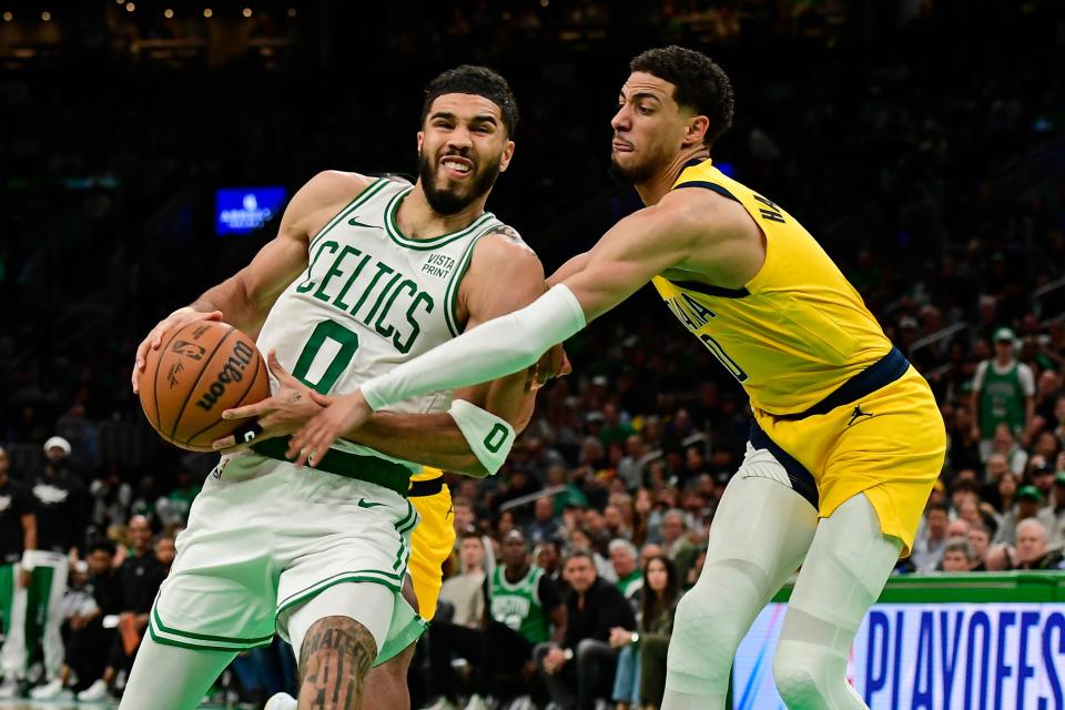 Jayson Tatum dribbles the ball against the Indiana Pacers' Tyrese Haliburton during Game 1 of the Eastern Conference finals.
