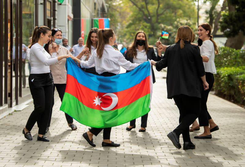 FILE PHOTO: People take part in celebrations following the signing of a deal to end the military conflict over the Nagorno-Karabakh region in Baku