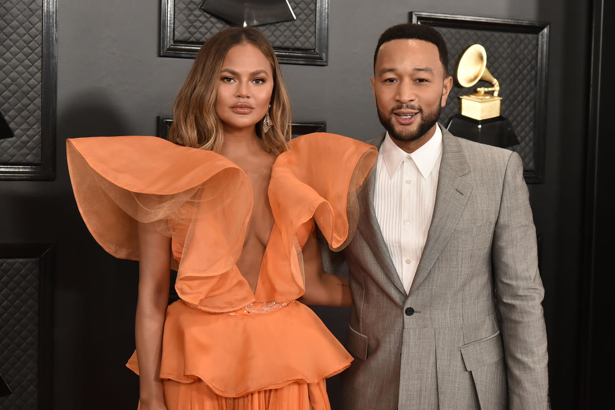 John Legend (pictured with wife Chrissy Teigen) is defending remarks he made about President Trump in a new Cosmopolitan interview. (Photo: David Crotty/Patrick McMullan via Getty Images)