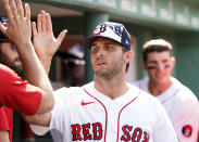 Boston Red Sox pitcher Kutter Crawford is congratulated by teammates in the dugout after leaving during the eighth inning of a baseball game against the Tampa Bay Rays at Fenway Park, Monday, July 4, 2022, in Boston. (AP Photo/Mary Schwalm)