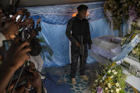 Jimmy Cherizier, aka Barbecue, a former policeman who leads the G9 gang coalition, holds a weapon as he stands next to the coffin that contain the remains of Tonino Manino, one of his lieutenants, during a funeral service in Port-au-Prince, Haiti, Thursday, Sept. 30, 2021. Barbecue has been accused -- by local and national courts and the United Nations and other international organizations -- of participation in three massacres between 2018 and 2020. There is a warrant for his arrest, although he's "hiding" in plain sight, protected by gunmen. (AP Photo/Rodrigo Abd)
