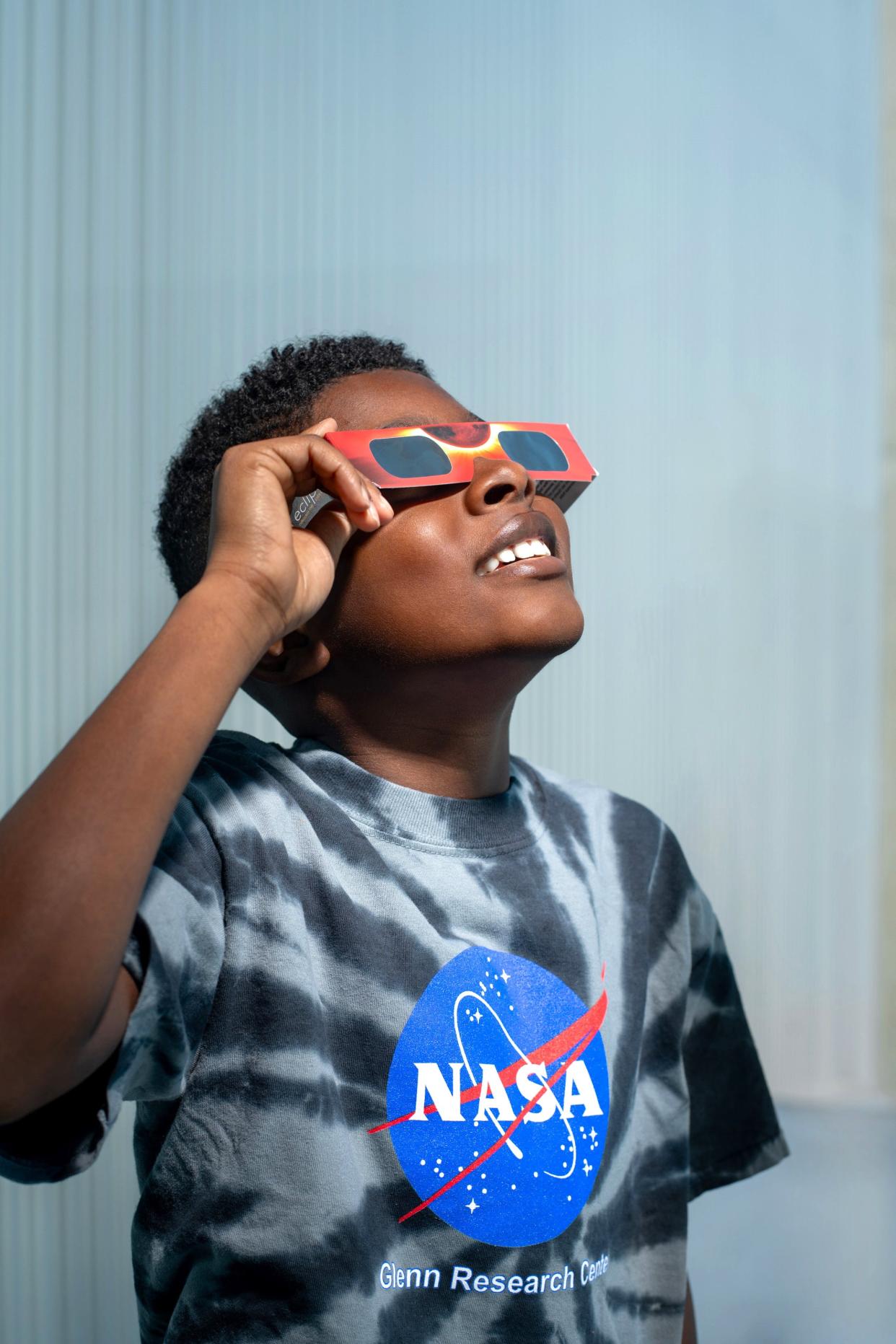 A child models a pair of eclipse glasses. Children in Holmes and Wayne counties will not be in school for the eclipse, as all area districts have closed for the day Monday, April 8.