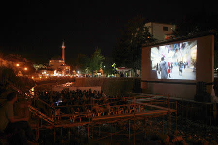 Kosovars and foreign visitors take their seats on a raised platform to watch a documentary film during Dokufest in Prizren August 20, 2014. REUTERS/Hazir Reka