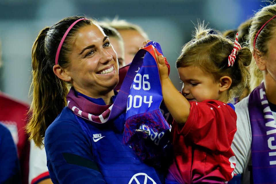 Alex Morgan, left, holds her daughter Charlie Elena Carrasco at an event in 2022.
