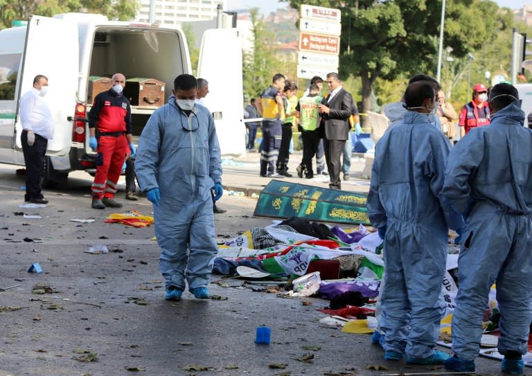 Emergency services personnel prepare to transport the bodies of victims away from the site of twin explosions at the main train station in Turkey's capital Ankara, on October 10, 2015