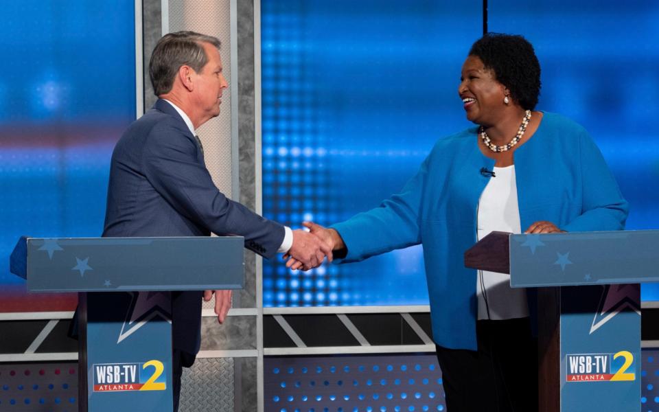 Republican Georgia Gov. Brian Kemp, left, shakes hands with Democratic challenger Stacey Abrams following a televised debate, in Atlanta - AP