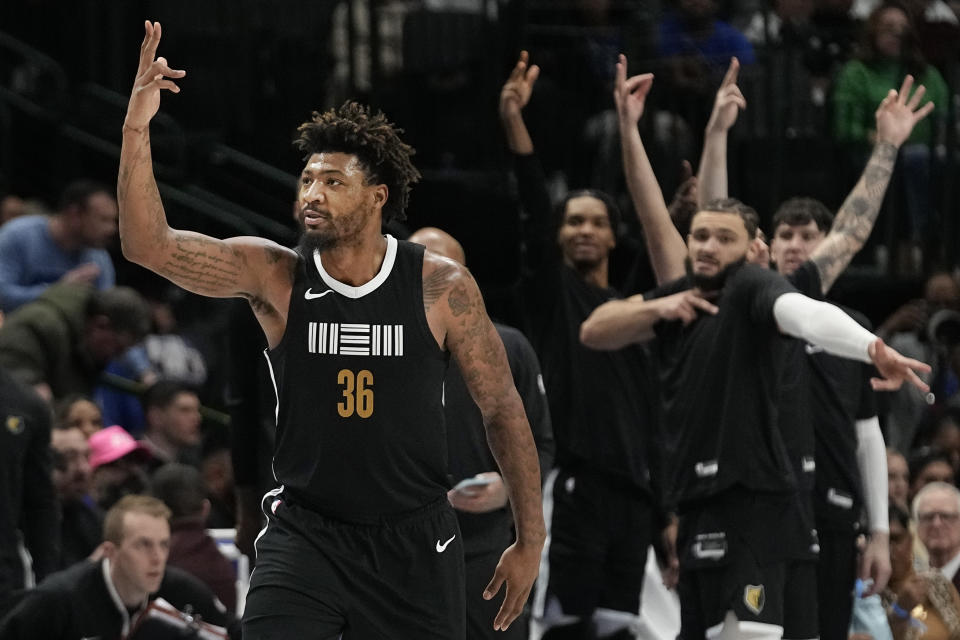 Memphis Grizzlies guard Marcus Smart (36) celebrates scoring a three pointer during the second half of an NBA basketball game against the Dallas Mavericks in Dallas, Tuesday, Jan. 9, 2024. (AP Photo/LM Otero)