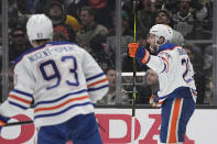 Edmonton Oilers center Leon Draisaitl, right, celebrates his goal as center Ryan Nugent-Hopkins skates behind during Game 3 of an NHL hockey Stanley Cup first-round playoff series against the Los Angeles Kings Friday, April 26, 2024, in Los Angeles. (AP Photo/Mark J. Terrill)