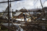 <p>Lex Kools leaves food and water for his neighbors’ dogs in the Cole Bay community, in the aftermath of Hurricane Irma, in St. Martin, Tuesday, Sept. 12, 2017. Hundreds of people across an island shared by Dutch St. Martin and French St. Martin are trying to rebuild the lives they had before it was pummeled by a Category 5 storm. (Photo: Carlos Giusti/AP) </p>