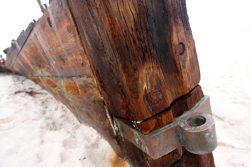 In this Wednesday, Sept. 5, 2012 photo, the remains of an old wooden ship rest along a private beach at Fort Morgan, Ala. The ship is the Rachel, a schooner built in Pascagoula, Miss., during World War I, according to Mike Bailey, historian with the Fort Morgan Historical Society. The ship was lost in a storm in 1923. The remains of the the Rachel have been uncovered by hurricanes in the past, but more of the wreck was revealed in the wake of Hurricane Isaac. (AP Photo/Press-Register, Brian Kelly) MAGS OUT