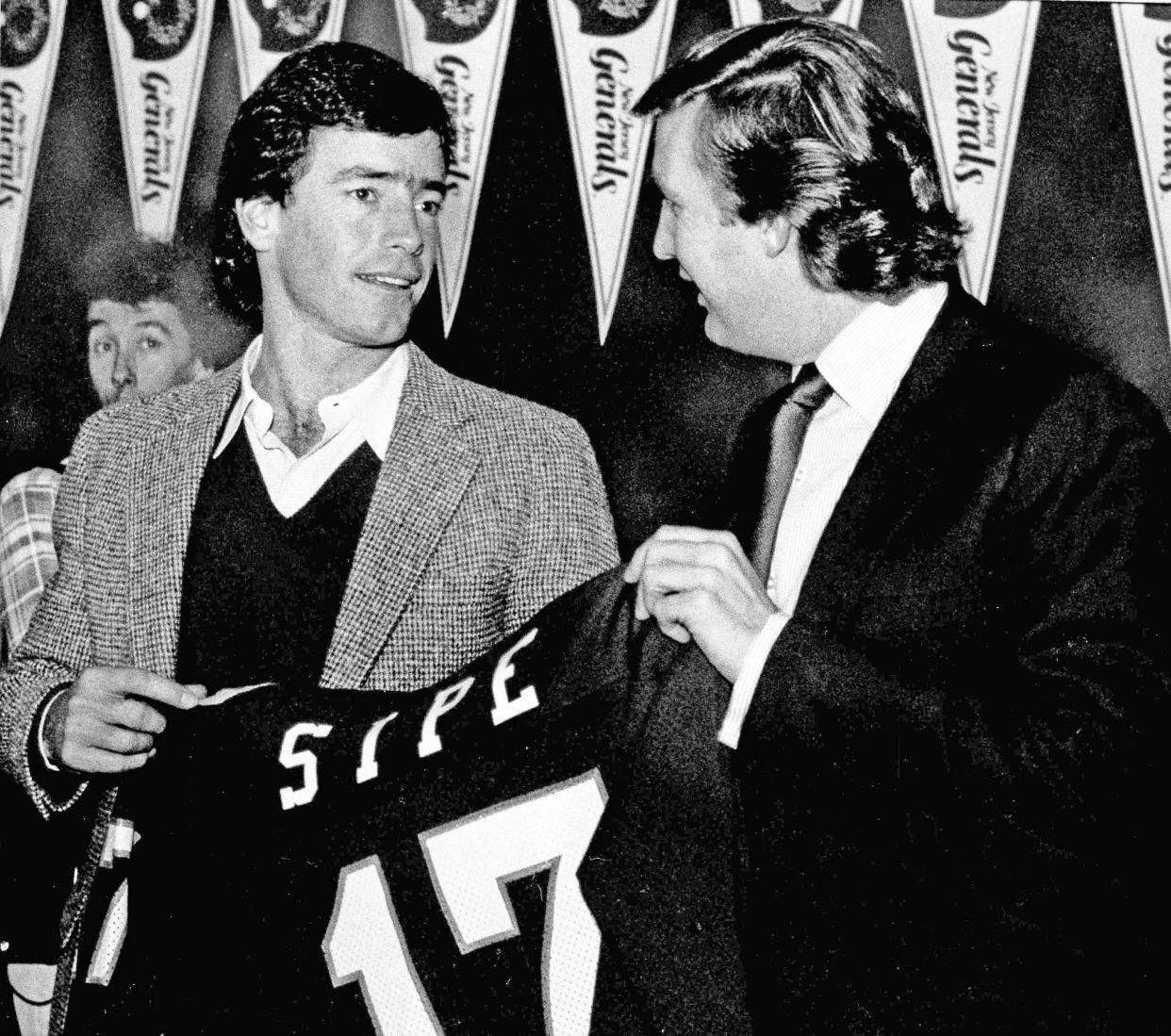 Cleveland Browns quarterback Brian Sipe, left, and New Jersey Generals owner Donald J. Trump hold up Sipe's new uniform jersey at a press conference, on Dec. 27, 1983 at Giants Stadium in East Rutherford, N.J., where Sipe was introduced as a General. Sipe made the jump to the USFL after playing for the NFL for 10 years.