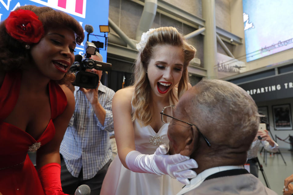 The Victory Belles plant kisses on World War II veteran Lawrence Brooks after singing him happy birthday, celebrating his 110th birthday at the National World War II Museum in New Orleans, Thursday, Sept. 12, 2019. Brooks was born Sept. 12, 1909, and served in the predominantly African-American 91st Engineer Battalion, which was stationed in New Guinea and then the Philippines during World War II. He was a servant to three white officers in his battalion. (AP Photo/Gerald Herbert)