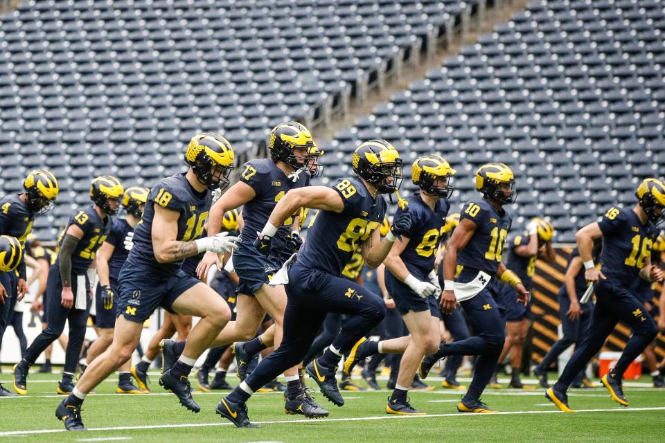 Michigan players warm up during open practice at NRG Stadium in Houston on Saturday, Jan. 6, 2024.