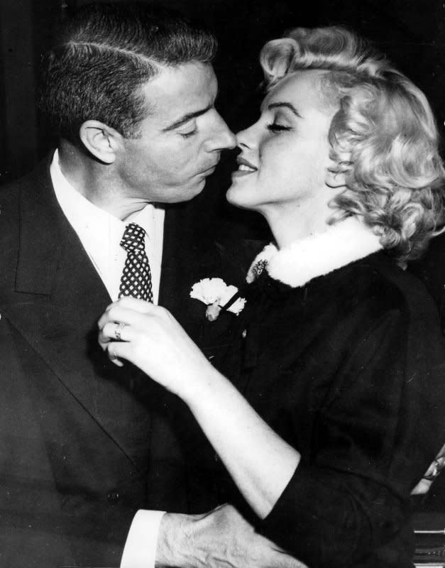 Marilyn Monroe prepares to kiss her husband, former baseball player Joe DiMaggio after their wedding January 15, 1954. File Photo courtesy Macfadden Publications/Wikimedia