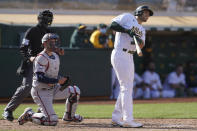 Oakland Athletics' Matt Olson, right, watches his grand slam home run in front of Minnesota Twins catcher Mitch Garver during the fourth inning of the first baseball game of a doubleheader in Oakland, Calif., Tuesday, April 20, 2021. (AP Photo/Jeff Chiu)