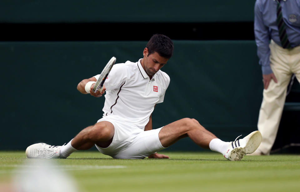 Serbia's Novak Djokovic slips over during his match against USA's Bobby Reynolds during day four of the Wimbledon Championships at The All England Lawn Tennis and Croquet Club, Wimbledon.
