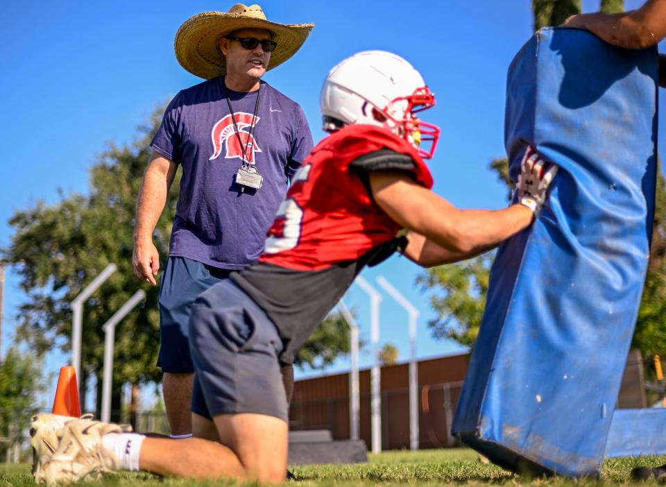 Head Football Coach Jeromy Blackwell works with his team on Wednesday, July 26, 2023 at Strathmore High School. Blackwell has returned to the job he loves and is still recovering after a life-threatening health scare that put him in the hospital for two weeks in June.