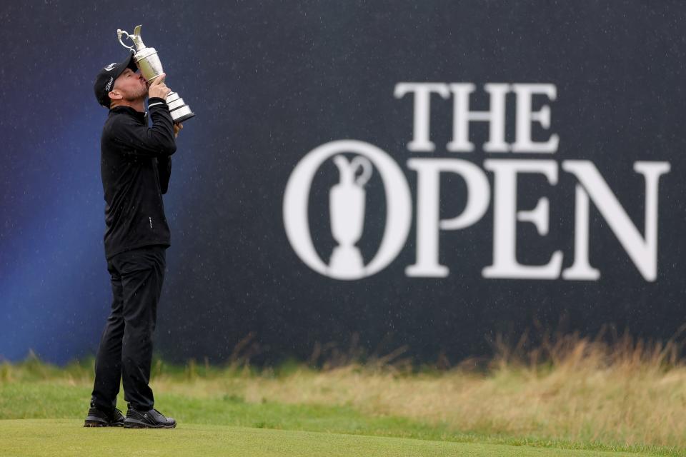 Brian Harman of the United States kisses the Claret Jug whilst celebrating winning the The Open on the 18th green on Day Four of The 151st Open at Royal Liverpool Golf Club in Hoylake, England, on July 23, 2023.