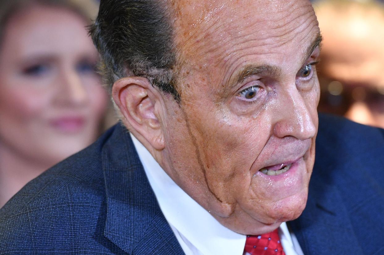 <p>Trump's personal lawyer Rudy Giuliani perspires as he speaks during a press conference at the Republican National Committee headquarters in Washington DC (Photo by MANDEL NGAN / AFP) (Photo by MANDEL NGAN/AFP via Getty Images)</p> (AFP via Getty Images)