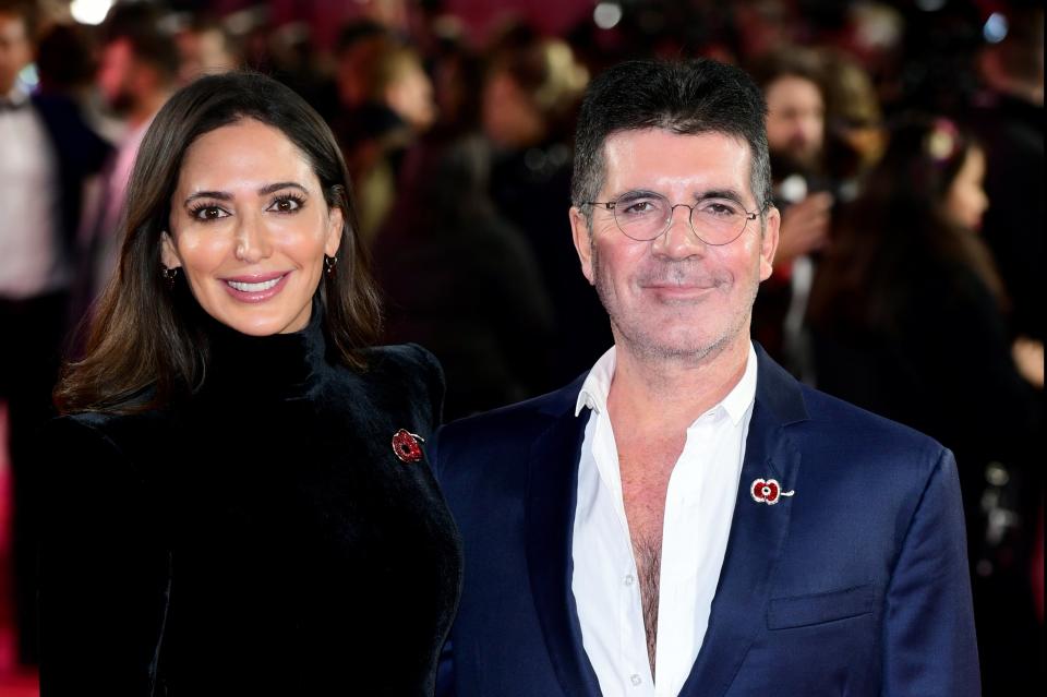 <p>Simon Cowell with his partner Lauren Silverman</p> (PA)