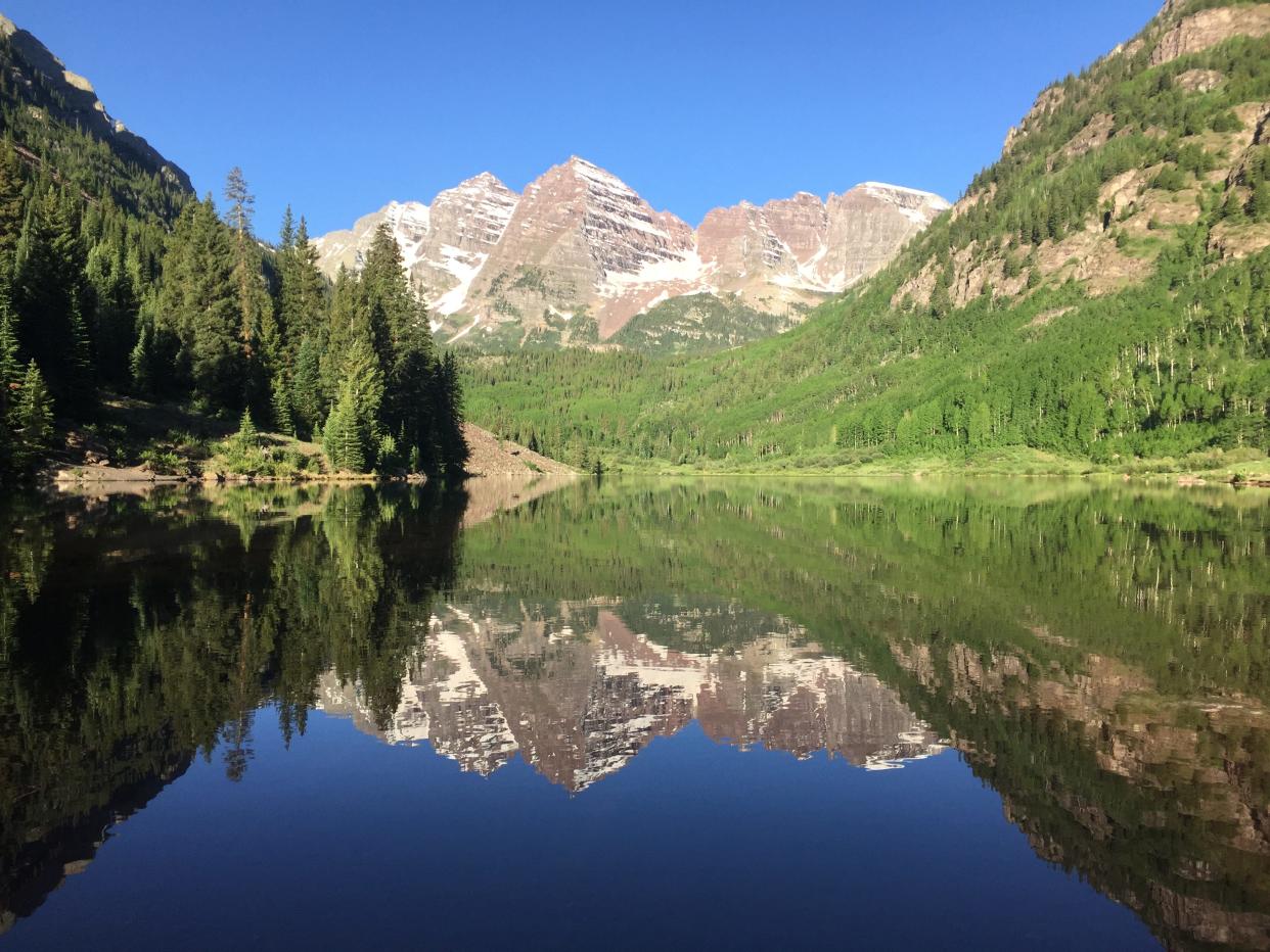 The famed Maroon Bells are pictured shortly after sunrise on June 13, 2018 just outside Aspen, Colorado.