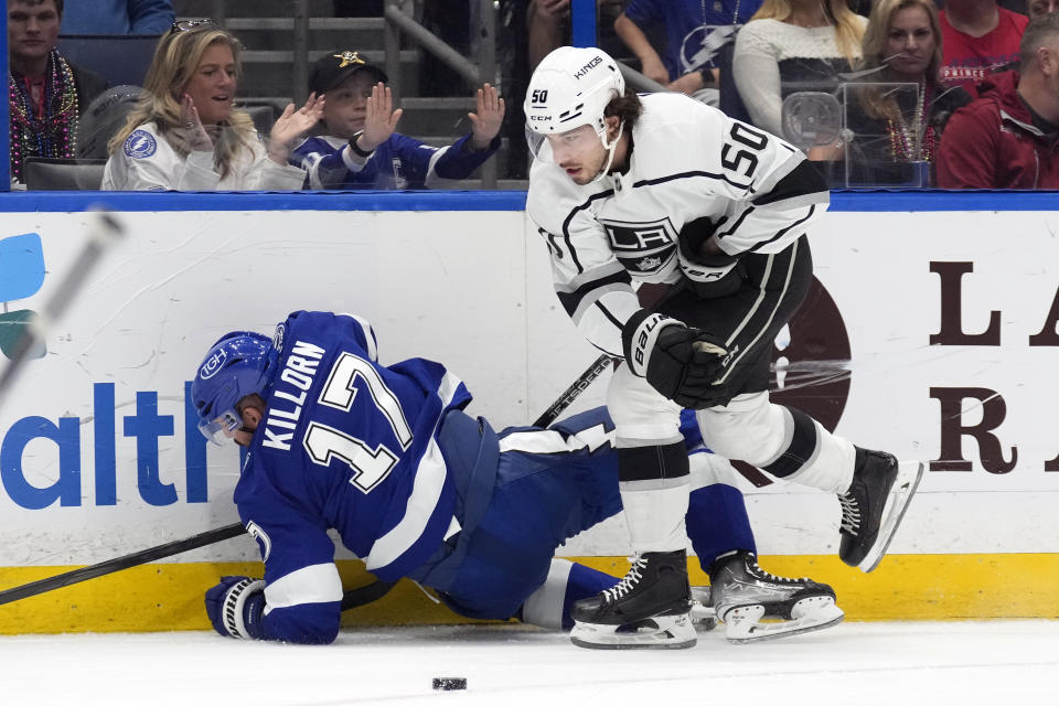 Los Angeles Kings defenseman Sean Durzi (50) knocks down Tampa Bay Lightning left wing Alex Killorn (17) during the second period of an NHL hockey game Saturday, Jan. 28, 2023, in Tampa, Fla. (AP Photo/Chris O'Meara)