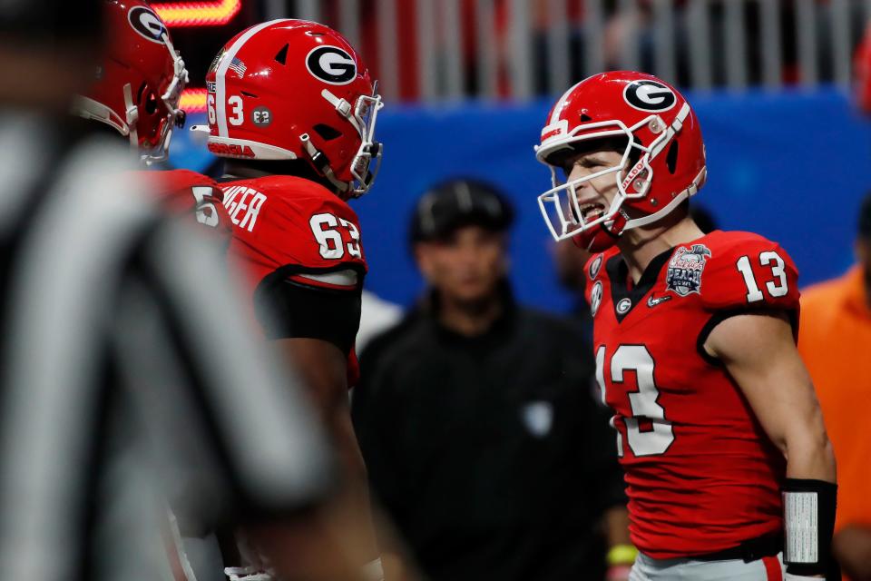 Georgia quarterback Stetson Bennett (13) celebrates after running in a touchdown during the first half of the Chick-fil-A Peach Bowl NCAA College Football Playoff semifinal game on Saturday, Dec 31, 2022, in Atlanta.
