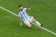 Argentina's Lionel Messi celebrates after scoring his side's first goal on a penalty kick during the World Cup final soccer match between Argentina and France at the Lusail Stadium in Lusail, Qatar, Sunday, Dec. 18, 2022. (AP Photo/Hassan Ammar)