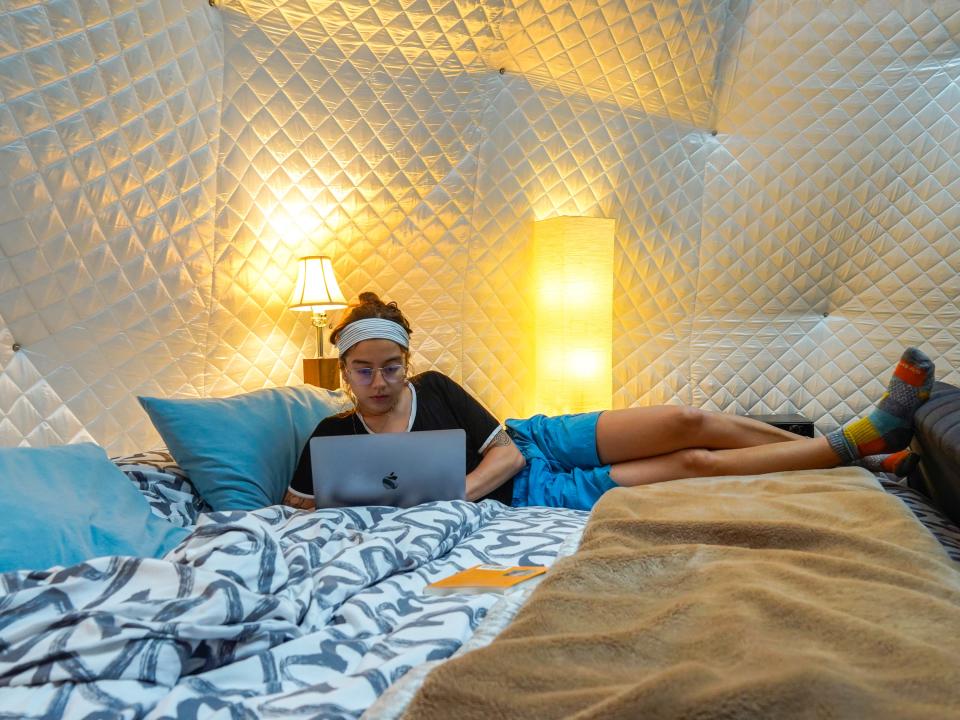 The author works on her laptop in bed in the dome