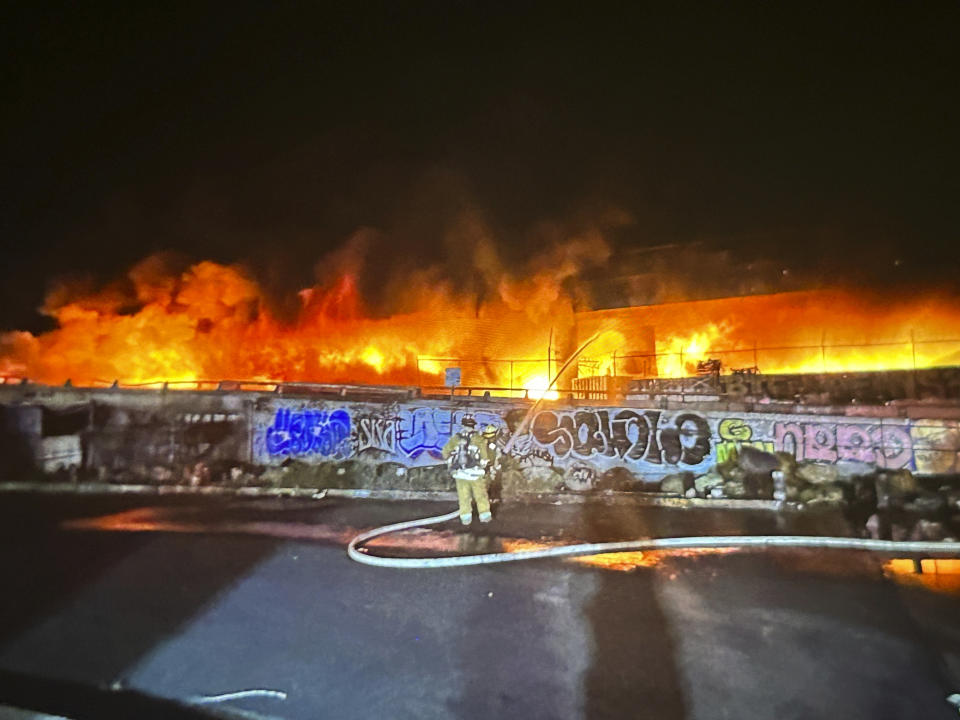 This photo provided by the California Department of Transportation shows an early morning fire along Interstate 10 near downtown Los Angeles, Saturday, Nov. 11, 2023. (Caltrans District 7 via AP)