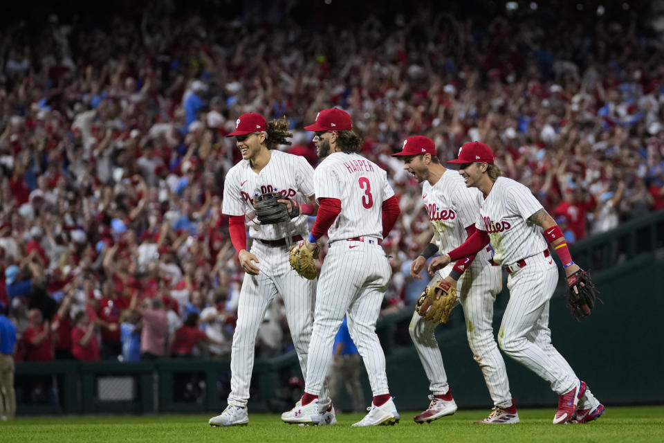 Philadelphia Phillies' Alec Bohm, Bryce Harper, Trea Turner and Bryson Stott, from left, celebrate the team's win over the Miami Marlins in Game 2 of an NL wild-card baseball playoff series Wednesday, Oct. 4, 2023, in Philadelphia. The Phillies swept the series, and move on to face the Atlanta Braves. (AP Photo/Matt Slocum)