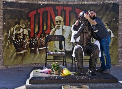 UNLV alumnus Taylor Oblad takes a &quot;selfie&quot; at the Jerry Tarkanian statue near the Thomas & Mack Center in Las Vegas, Wednesday, Feb. 11, 2015. Hall of Fame coach Jerry Tarkanian, who built a basketball dynasty at UNLV but was defined more by his decades-long battle with the NCAA, died Wednesday, Feb. 11, 2015, in Las Vegas after several years of health issues. He was 84.(AP Photo/The Sunm L.E. Baskow)