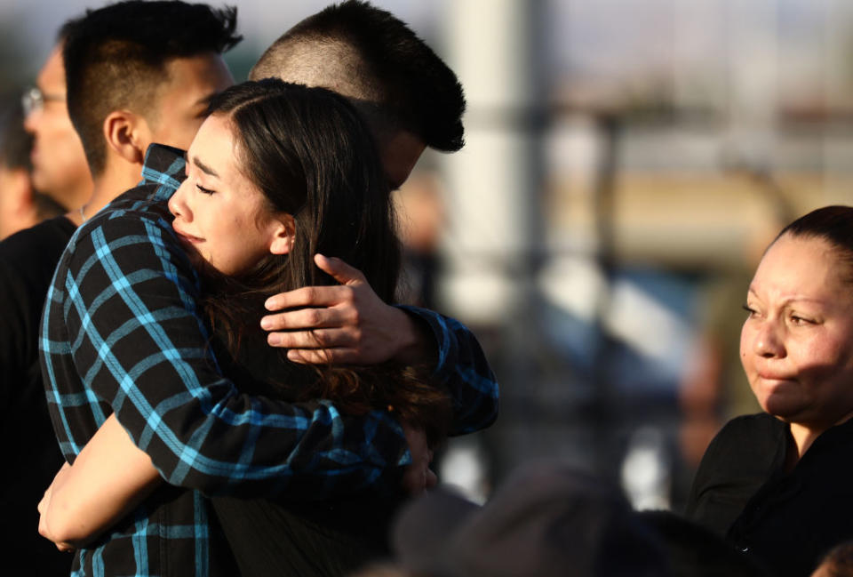 Mourners embrace at a vigil honoring Horizon High School sophomore Javier Amir Rodriguez, who lost his life in a mass shooting in nearby El Paso, on August 5, 2019 in Horizon City, Texas. The vigil was held at the school's football field. | Mario Tama—Getty Images